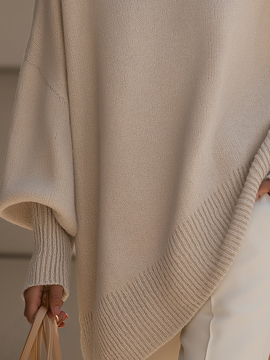 Oversized draped sweater with wide rounded neckline, ribbed cuffs and asymmetrical hem