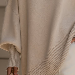 Oversized poncho-style sweater with round neckline, ribbed cuffs and hem in a neutral tone