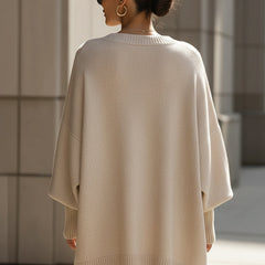 Oversized draped sweater with wide rounded neckline, ribbed cuffs and asymmetrical hem