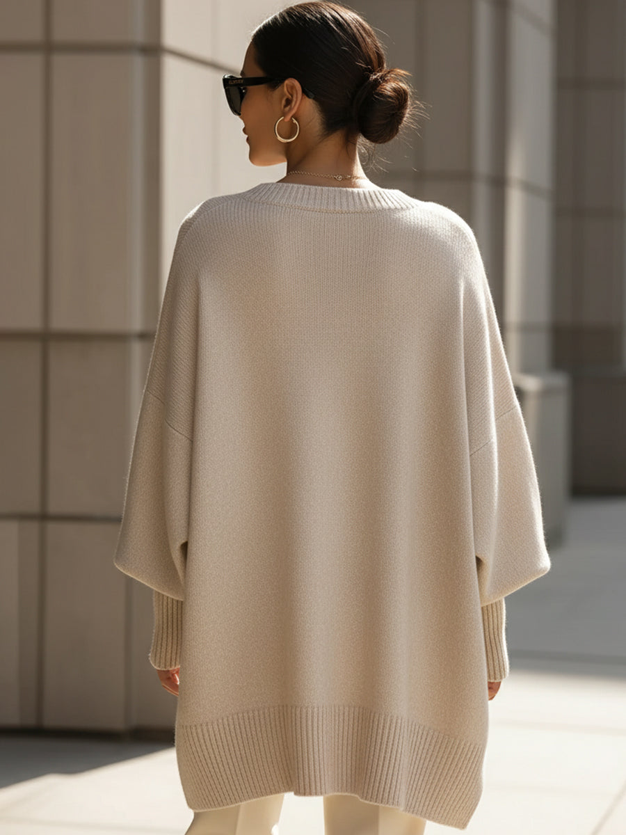 Oversized draped sweater with wide rounded neckline, ribbed cuffs and asymmetrical hem