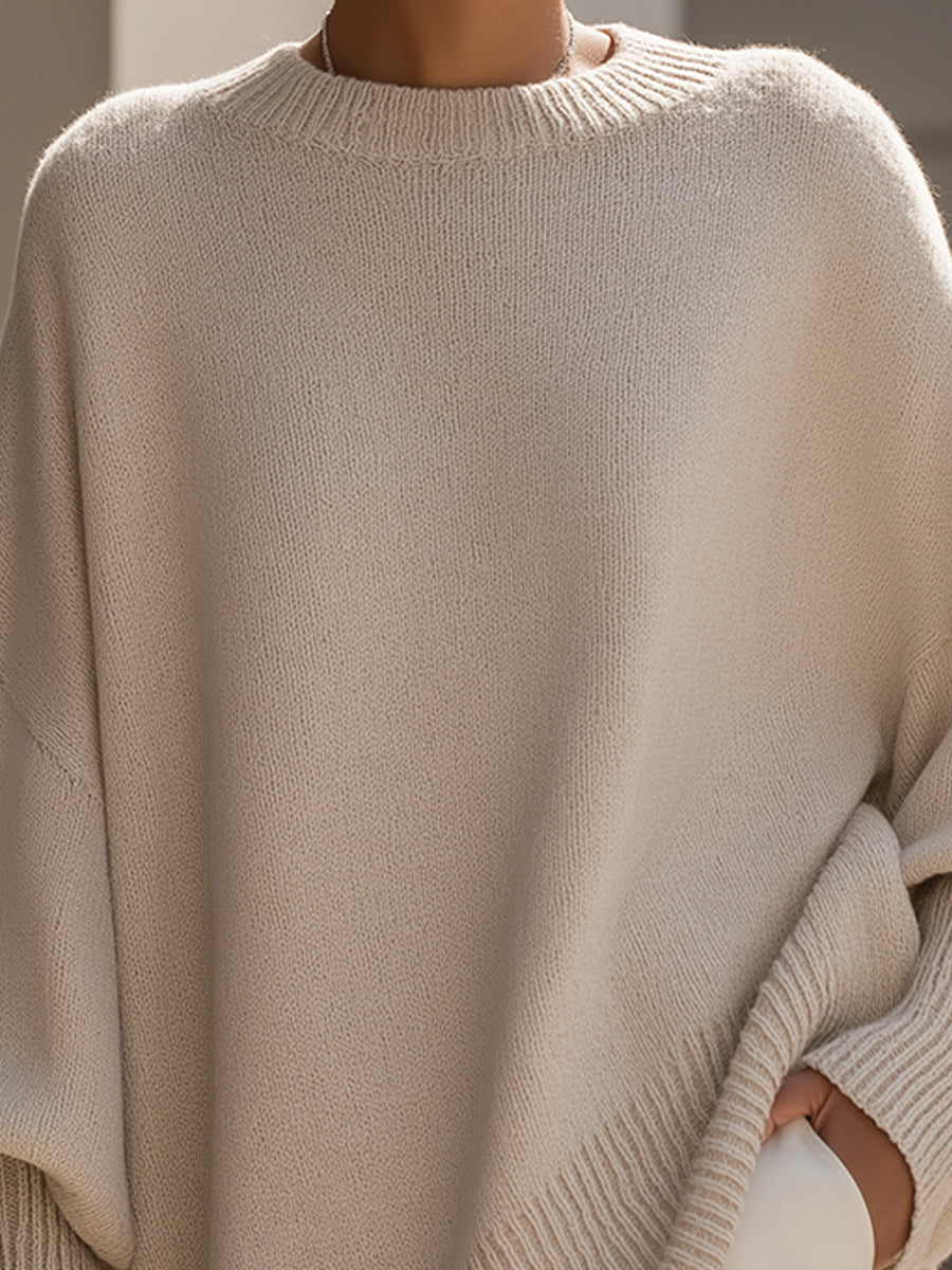 Oversized poncho-style sweater with round neckline, ribbed cuffs and hem in a neutral tone