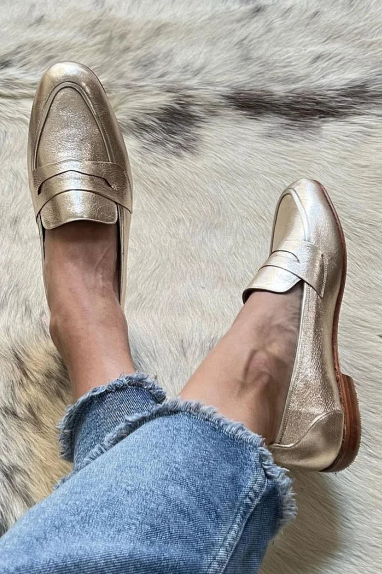 Shiny light gold metallic slip-on loafers for women with a clean silhouette