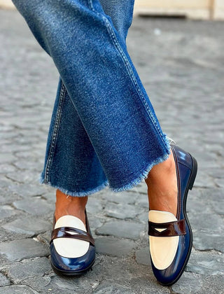 Navy blue two-tone loafer with contrast panels and a classic slip-on shape