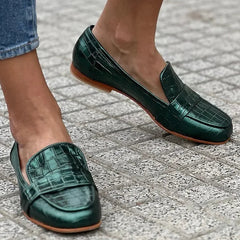 Green croc-effect tapered loafers with a glossy finish, styled for everyday wear