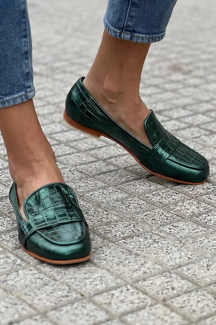 Green croc-effect tapered loafers with a glossy finish, styled for everyday wear