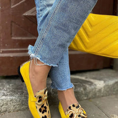 Yellow slip-on loafer with animal print tip and golden ring detail
