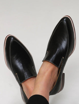 Black minimalist loafers with clean lines and a modern silhouette