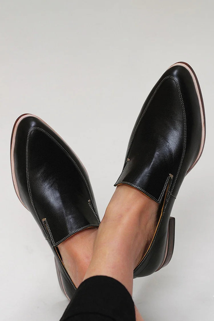 Black minimalist loafers with clean lines and a modern silhouette