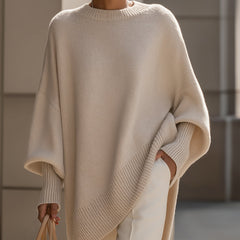 Oversized draped sweater with wide rounded neckline, ribbed cuffs and asymmetrical hem