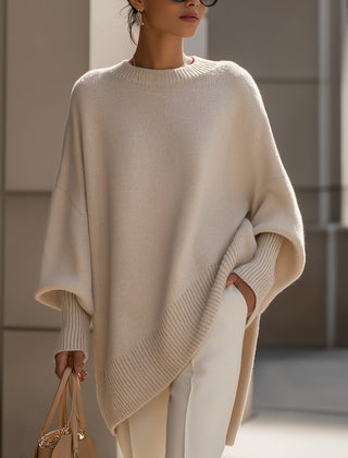 Oversized draped sweater with wide rounded neckline, ribbed cuffs and asymmetrical hem