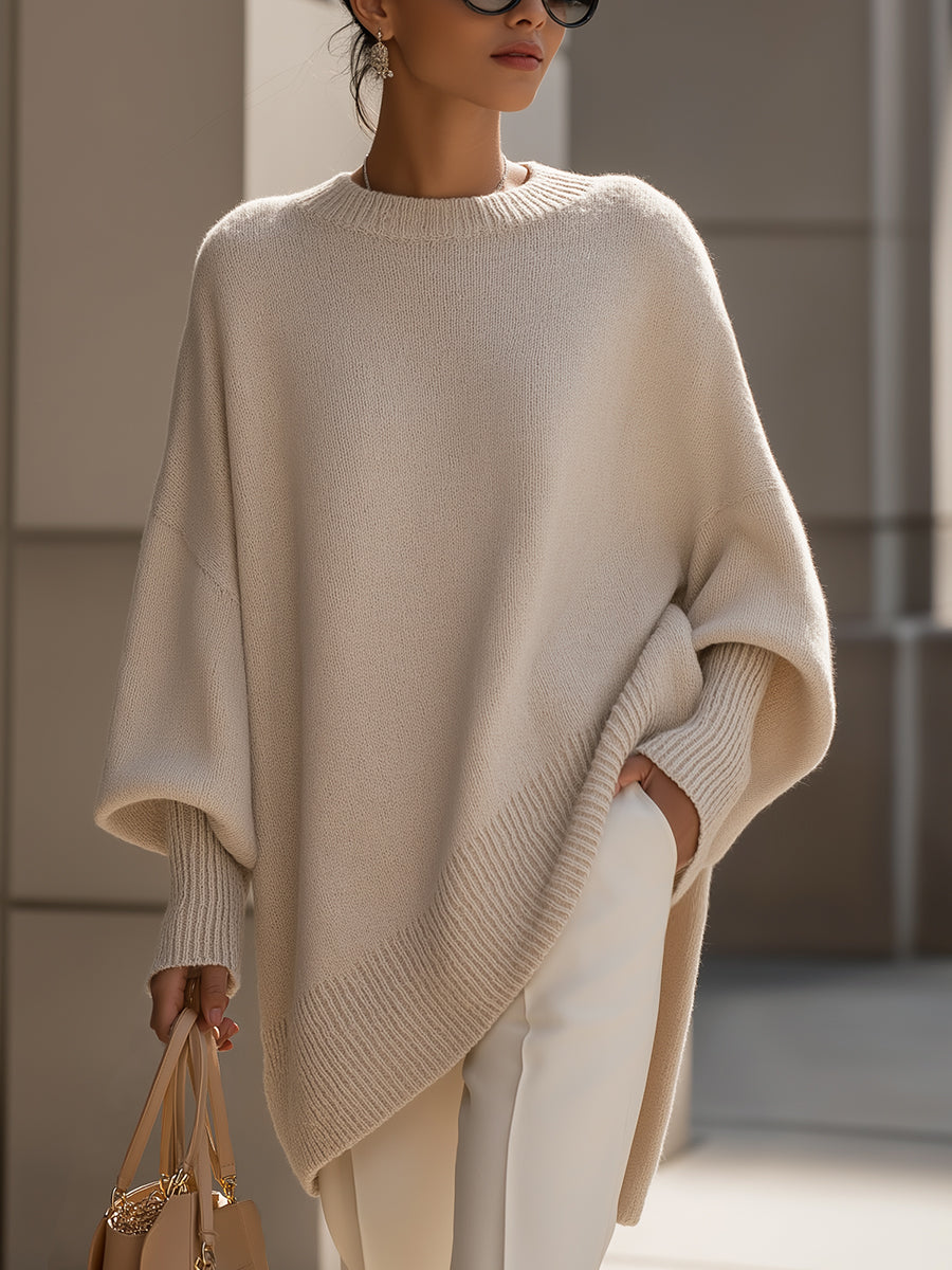 Oversized draped sweater with wide rounded neckline, ribbed cuffs and asymmetrical hem