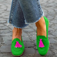 Bright green slip-on loafer with fuchsia tassel detail