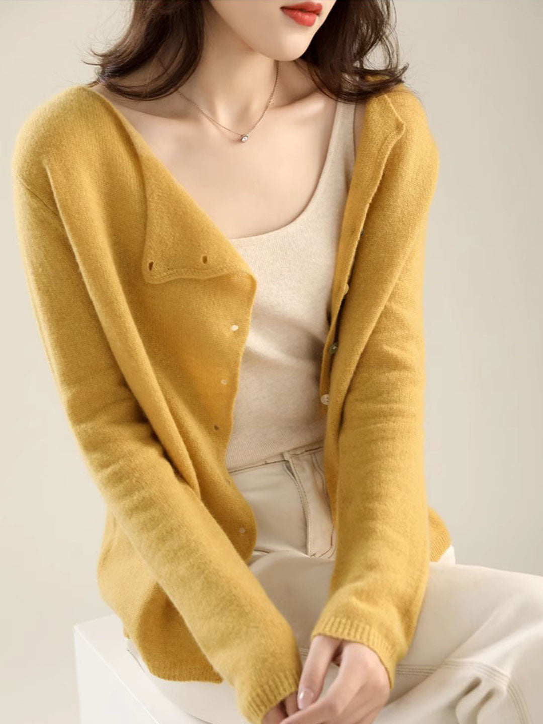 Women's V-neck button-front long sleeve cardigan with softly shaped collar and hip-length hem