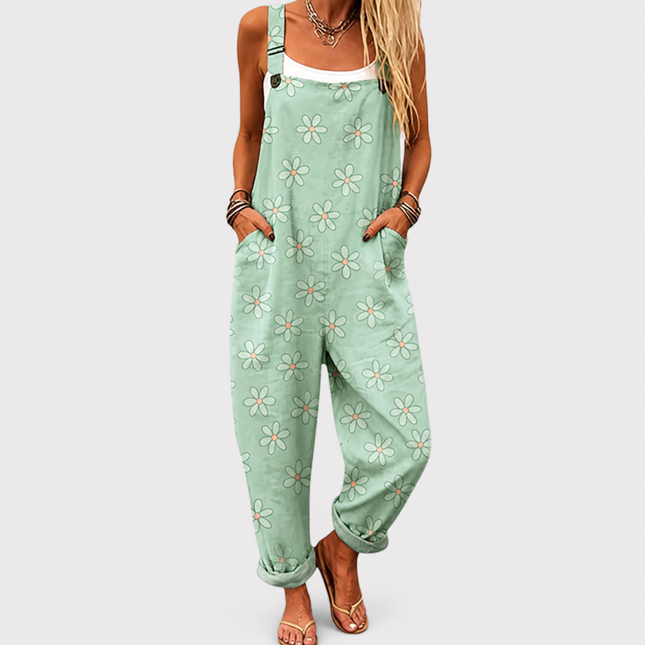 Woman wearing a printed wide-leg jumpsuit with adjustable straps and a relaxed, flattering fit