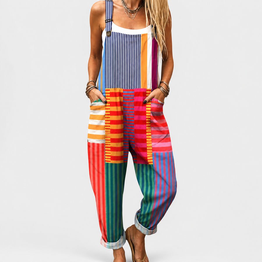 Woman wearing a printed wide-leg jumpsuit with adjustable straps and a flowing silhouette