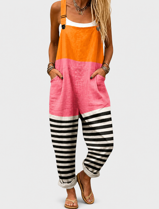 Woman wearing printed wide-leg overalls with adjustable straps in orange, pink or black