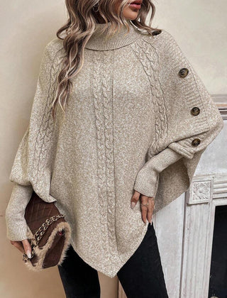 High neck batwing poncho sweater in cable knit with asymmetrical hem and button shoulder detail