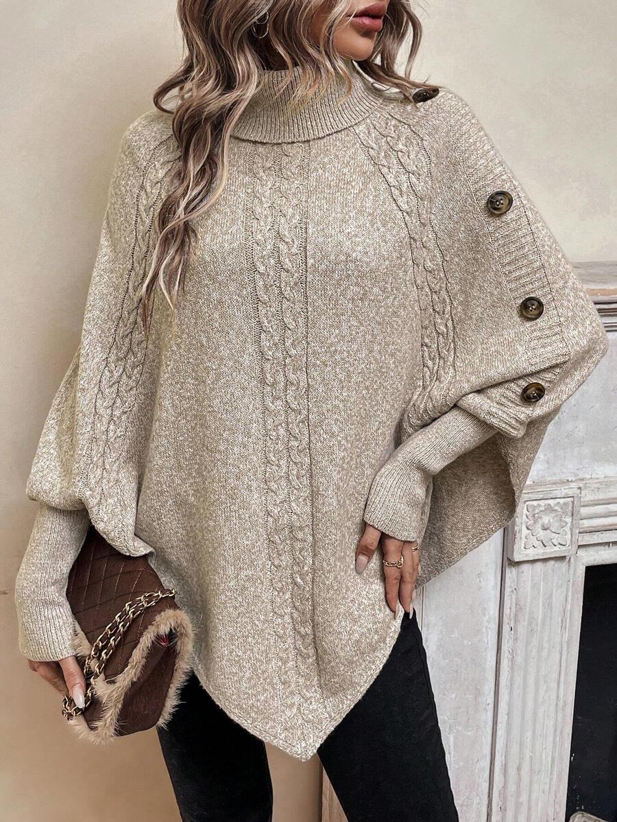 High neck batwing poncho sweater in cable knit with asymmetrical hem and button shoulder detail