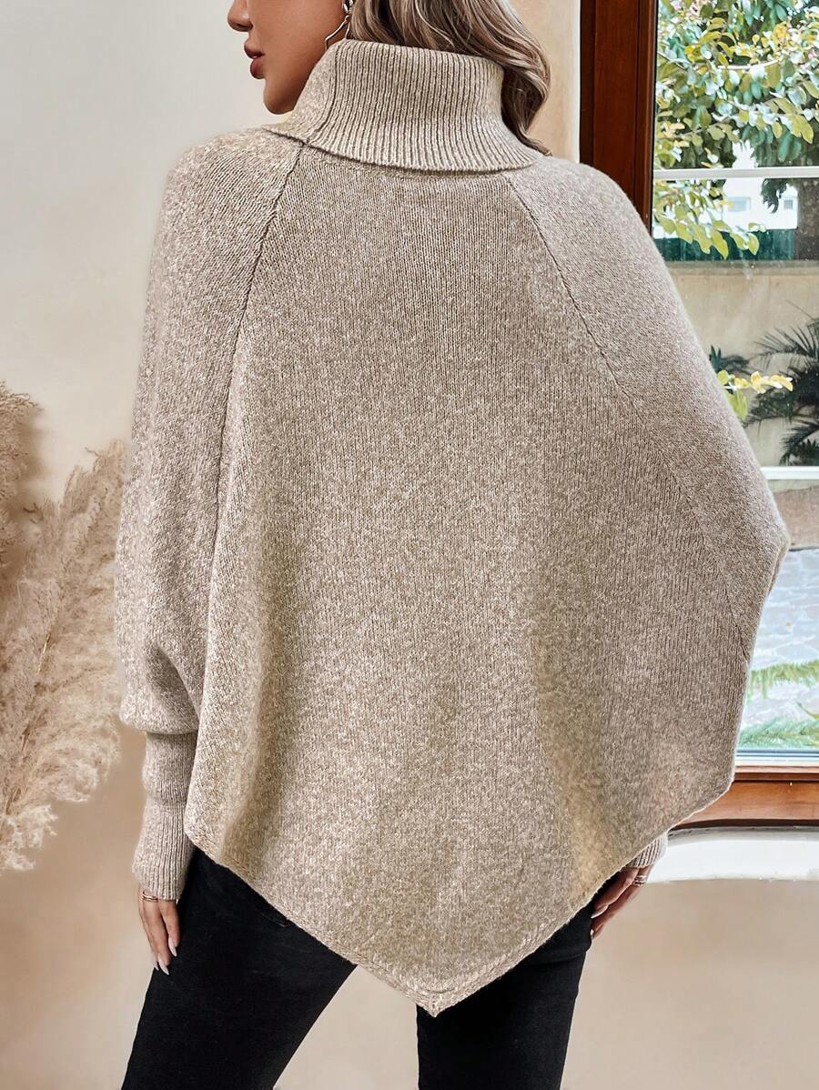 High neck batwing poncho sweater in cable knit with asymmetrical hem and button shoulder detail