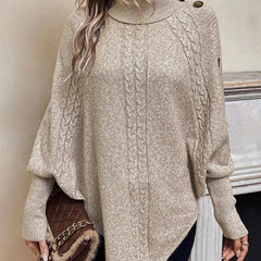 High neck batwing poncho sweater in cable knit with asymmetrical hem and button shoulder detail