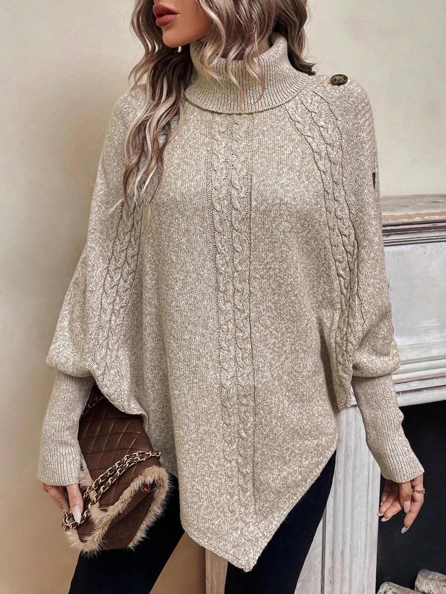 High neck batwing poncho sweater in cable knit with asymmetrical hem and button shoulder detail