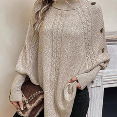 High neck batwing poncho sweater in cable knit with asymmetrical hem and button shoulder detail