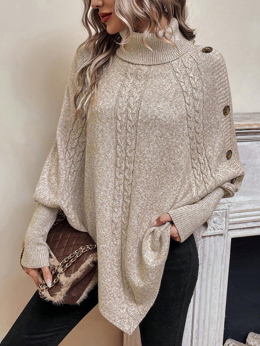 High neck batwing poncho sweater in cable knit with asymmetrical hem and button shoulder detail
