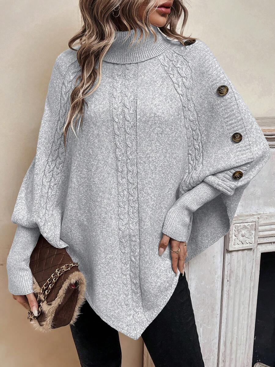 High neck batwing poncho sweater in cable knit with asymmetrical hem and button shoulder detail