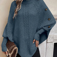 High neck batwing poncho sweater in cable knit with asymmetrical hem and button shoulder detail