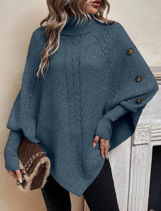 High neck batwing poncho sweater in cable knit with asymmetrical hem and button shoulder detail