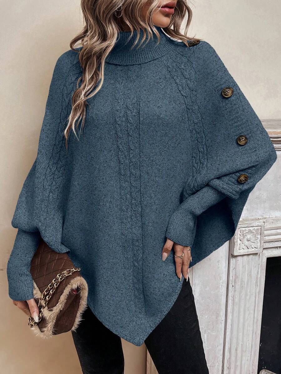 High neck batwing poncho sweater in cable knit with asymmetrical hem and button shoulder detail
