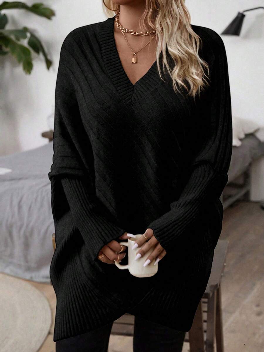 Oversized V-neck sweater with batwing sleeves and asymmetrical wrap hem in khaki and black