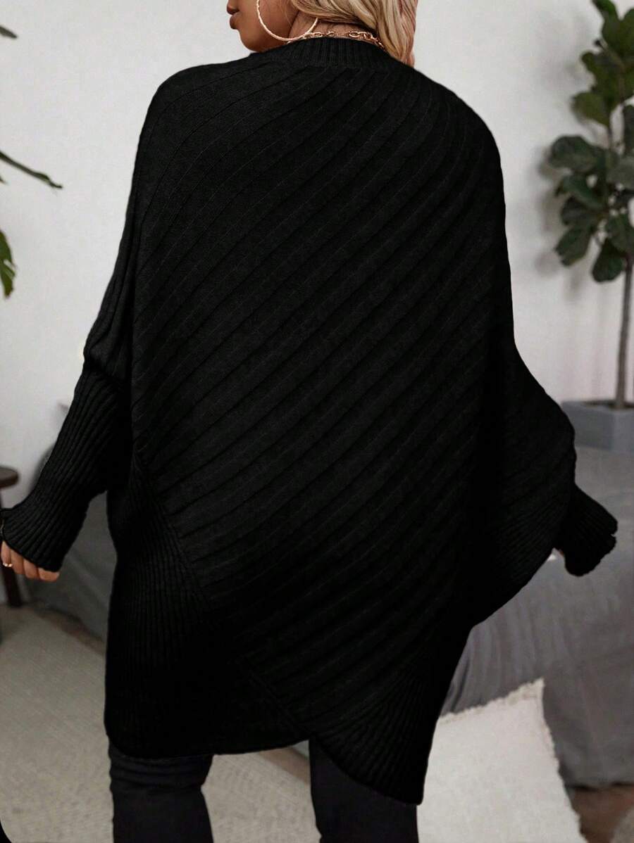Oversized V-neck sweater with batwing sleeves and asymmetrical wrap hem in khaki and black