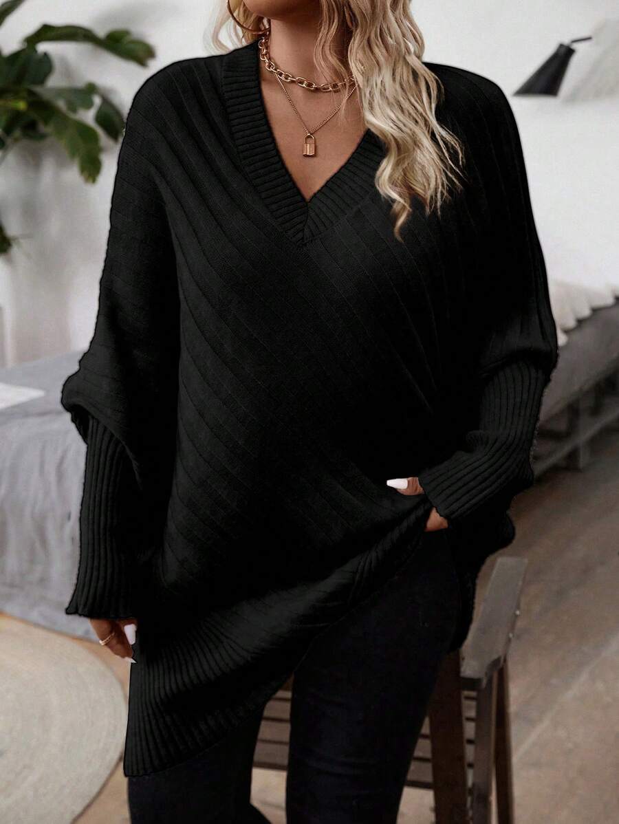 Oversized V-neck sweater with batwing sleeves and asymmetrical wrap hem in khaki and black