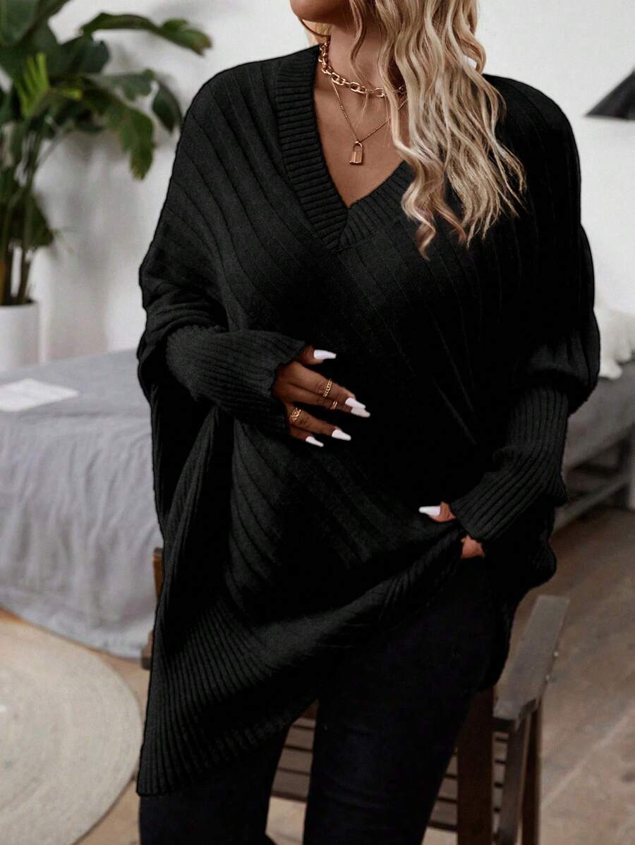 Oversized V-neck sweater with batwing sleeves and asymmetrical wrap hem in khaki and black