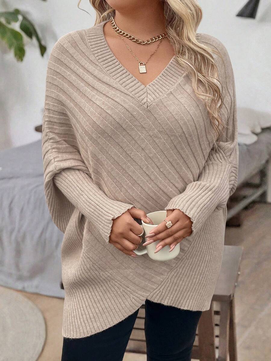 Oversized V-neck sweater with batwing sleeves and asymmetrical wrap hem in khaki and black