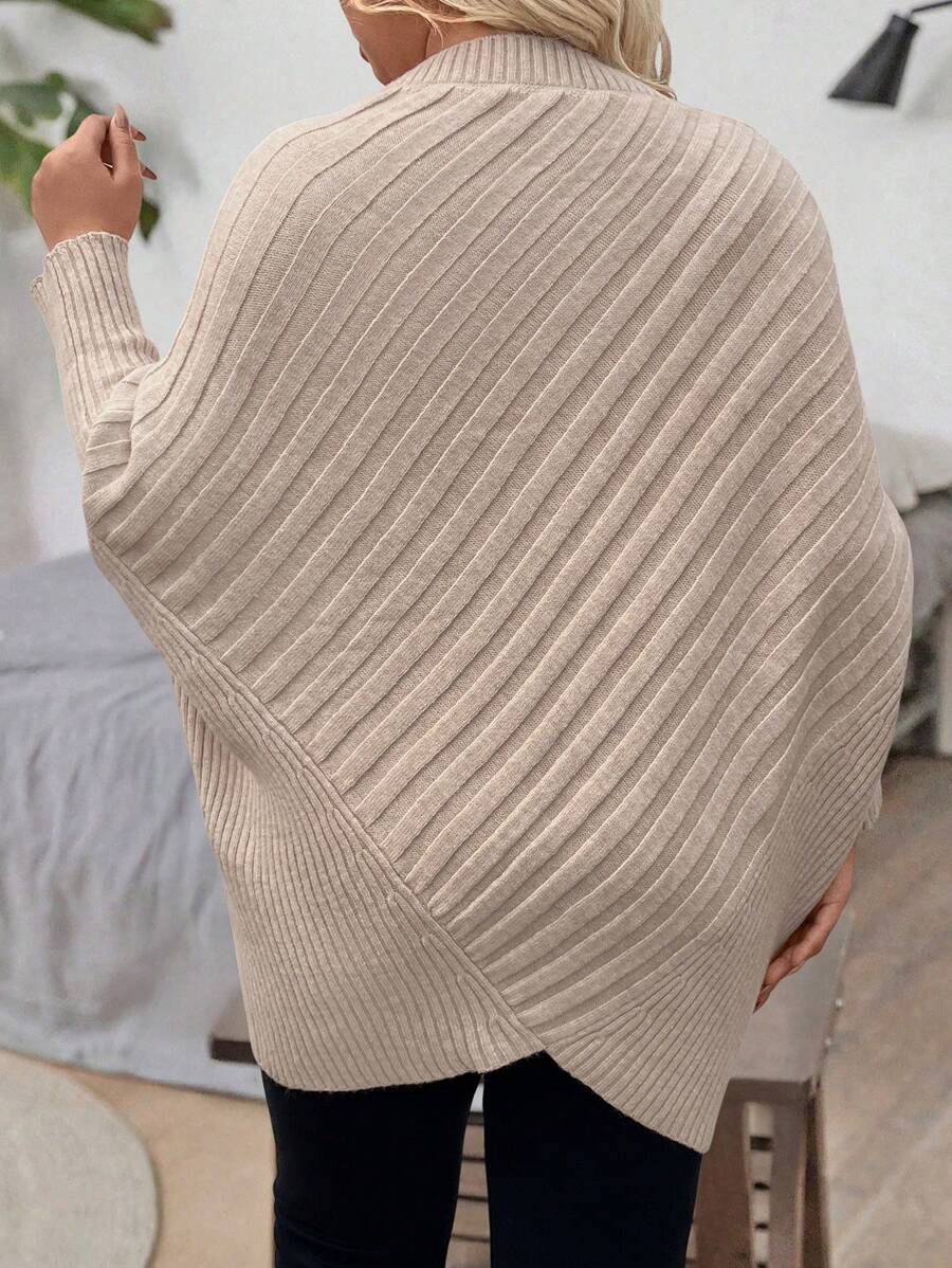 Oversized V-neck sweater with batwing sleeves and asymmetrical wrap hem in khaki and black