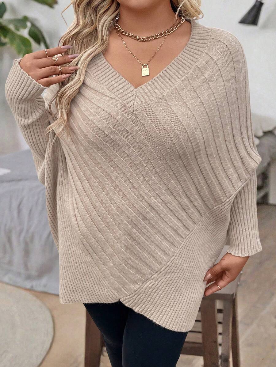 Oversized V-neck sweater with batwing sleeves and asymmetrical wrap hem in khaki and black