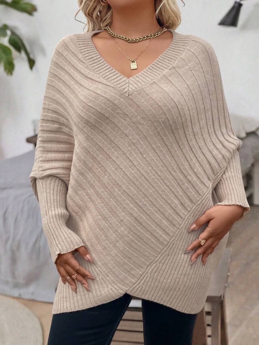 Oversized V-neck sweater with batwing sleeves and asymmetrical wrap hem in khaki and black