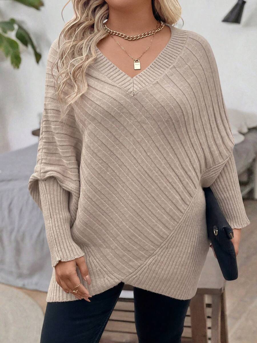 Oversized V-neck sweater with batwing sleeves and asymmetrical wrap hem in khaki and black
