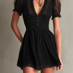 Black smocked mini dress with delicate lace trim at neckline and hem