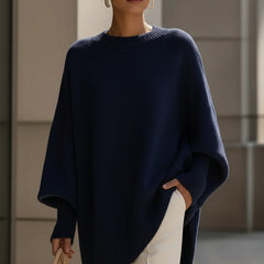 Oversized draped sweater with wide rounded neckline, ribbed cuffs and asymmetrical hem