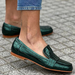 Green croc-effect tapered loafers with a glossy finish, styled for everyday wear