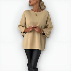 Oversized women's sweater with round neckline, three-quarter sleeves and button-detailed cuffs