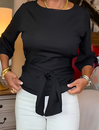 Woman wearing a tie waist flattering top with an adjustable soft waist tie