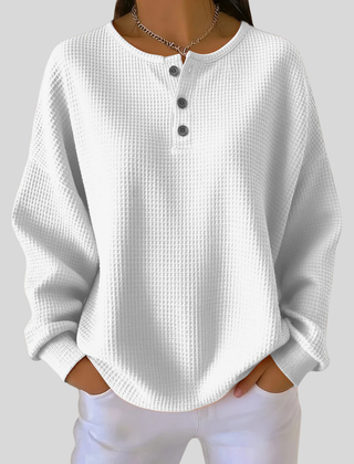 Relaxed-fit waffle-knit henley sweatshirt with button neckline, shown in several colours