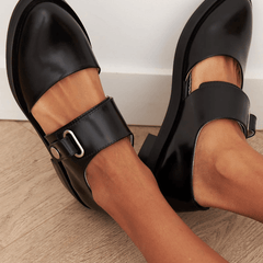 Black buckle loafers with polished finish and bold strap detail