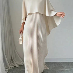 Elegant pleated cape maxi dress with flowing overlay and floor-length skirt