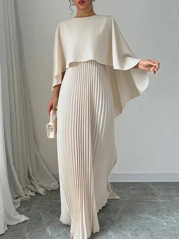 Elegant pleated cape maxi dress with flowing overlay and floor-length skirt
