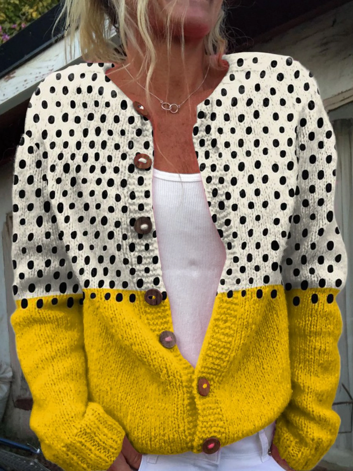 Two-tone knit cardigan with creamy polka-dot upper, mustard lower and wooden-look buttons